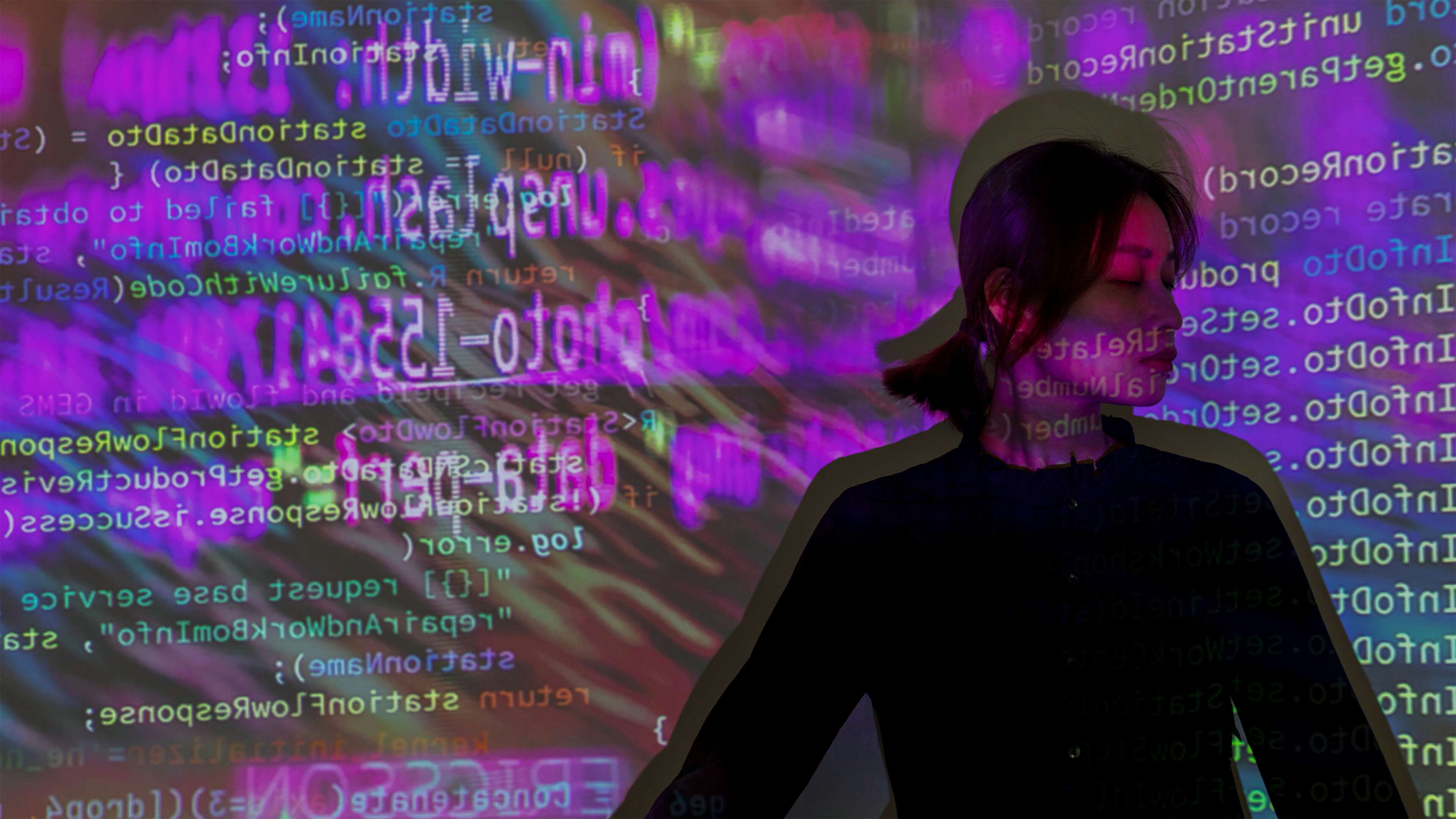 Ericsson 5G factory Nanjing woman in front of a code projection